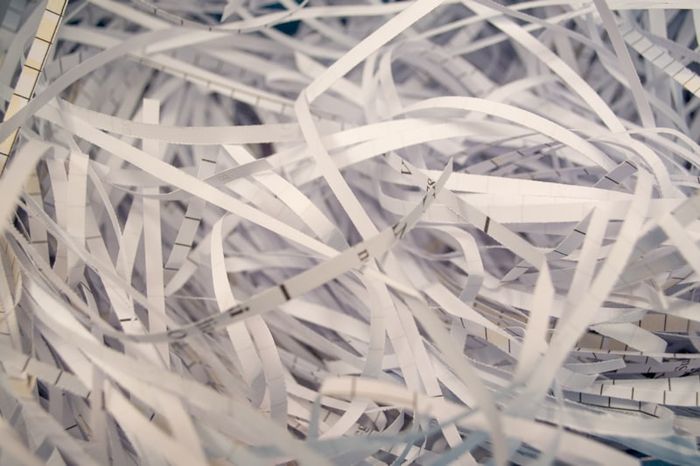 A paper shredder destroying sensitive documents to prevent identity theft