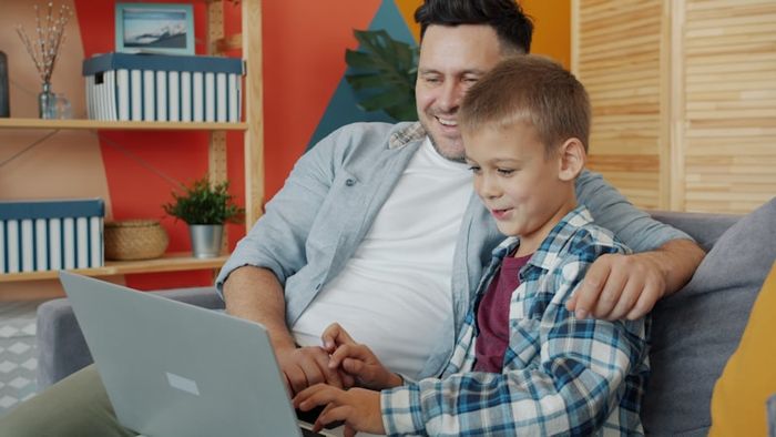 A family using a computer together, demonstrating supervised internet use