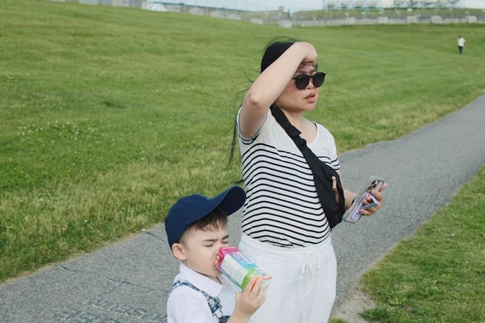 A parent and child looking at a phone together while setting up safety features